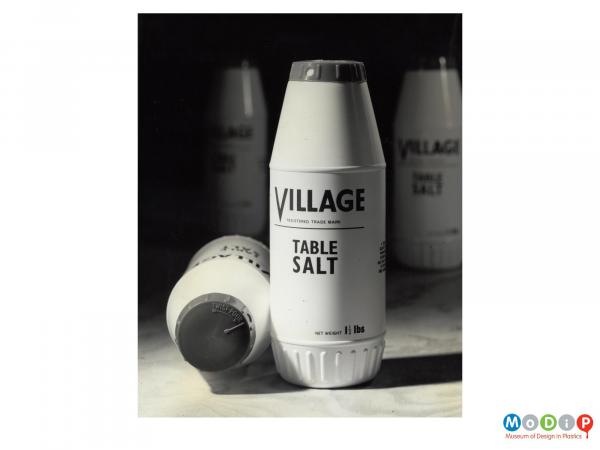 Scanned image showing table salt dispensers.