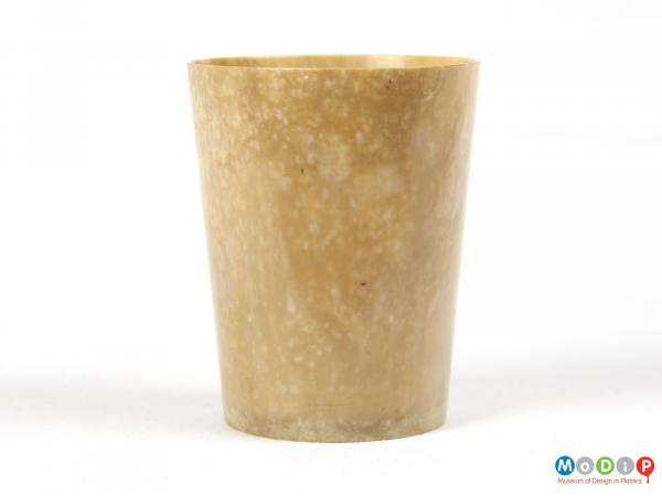 Side view of a beaker showing mottled material.