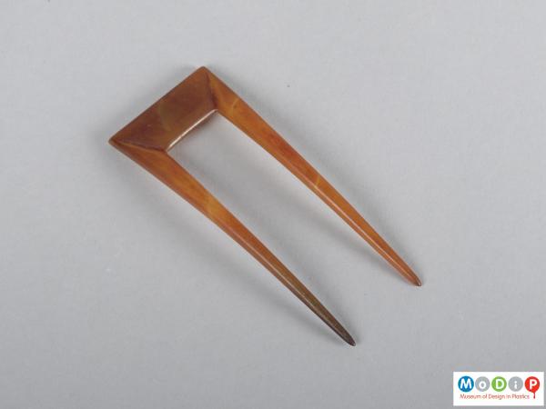 Top view of a hairpin showing the squared top and two teeth.