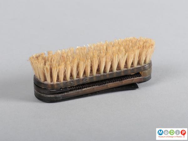 Side view of a brush and comb set showing the bristles and handle.