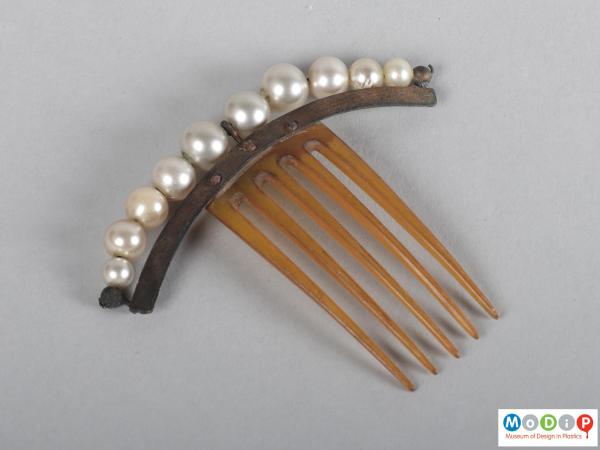 Top view of a comb showing the heading and teeth.