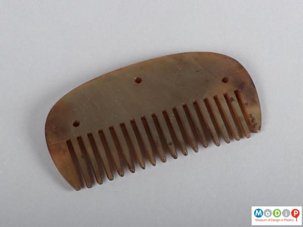 Top view of a comb showing the heading and teeth.