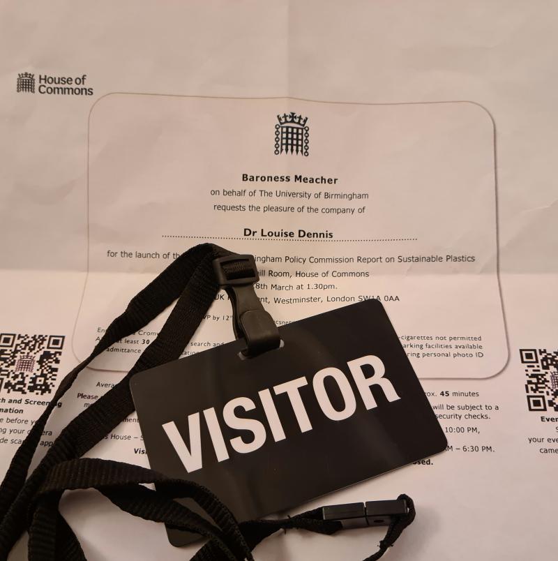 A visitor pass and a printed invitation.