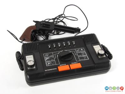 Top view of an Interstate TV game showing the switch, button and dial selection controls and the two hand-held controls fixed onto the console.