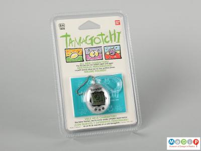 Front view of a Tamagotchi showing toy in its original packaging.
