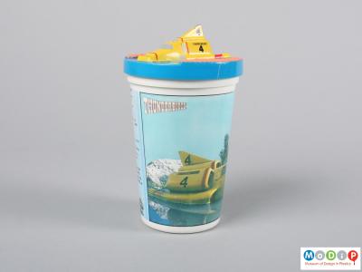 Side view of a beaker showing the moulded vehicle on the lid.