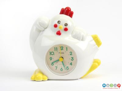Front view of an alarm clock showing the rooster's wings, feet and tail.