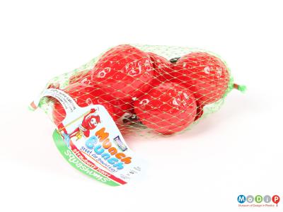 Side view of Squashums packaging showing the strawberry shapes in a net.