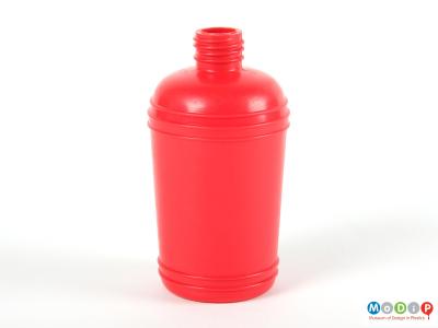 Side view of a red syrup bottle showing the moulded banding decoration.
