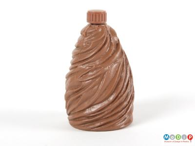 Side view of a syrup bottle showing the moulded texture.