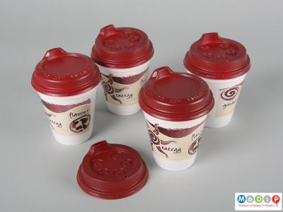 Top view  of a pair of Smart Lids and PS cups showing the two different types of lid.
