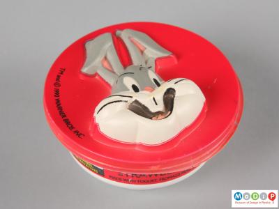 Top view of a Bugs Bunny mousse pot showing the vacuum formed face of Bugs Bunny.