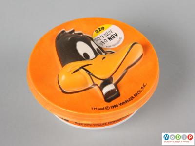 Top view of a Daffy Duck mousse pot showing the vacuum formed face on the lid.