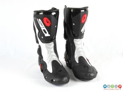 Front view of a pair of boots showing the shin plates and toe sliders.