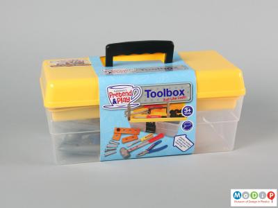Front view of a toy tool box showing the packaing slip around the box.