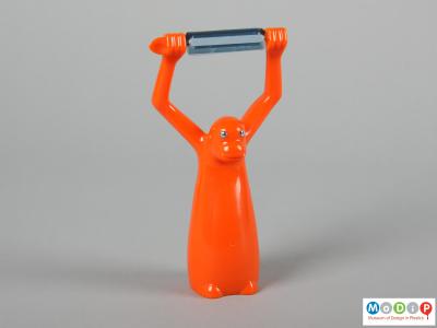Front view of a vegetable peeler showing the up stretched arms.