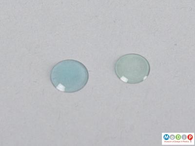 Front view of a pair of contact lenses showing the curved surface.