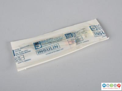 Front view of a syringe in sterile packaging.