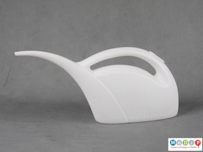 Side view of a watering can showing the curving neck.