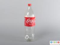 An empty Coca-Cola bottle with a red label and cap.